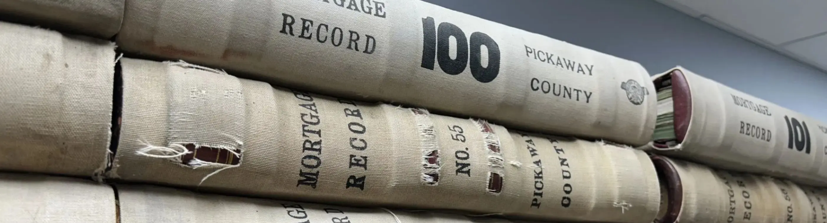 Red Pickaway County deed record books on shelves
